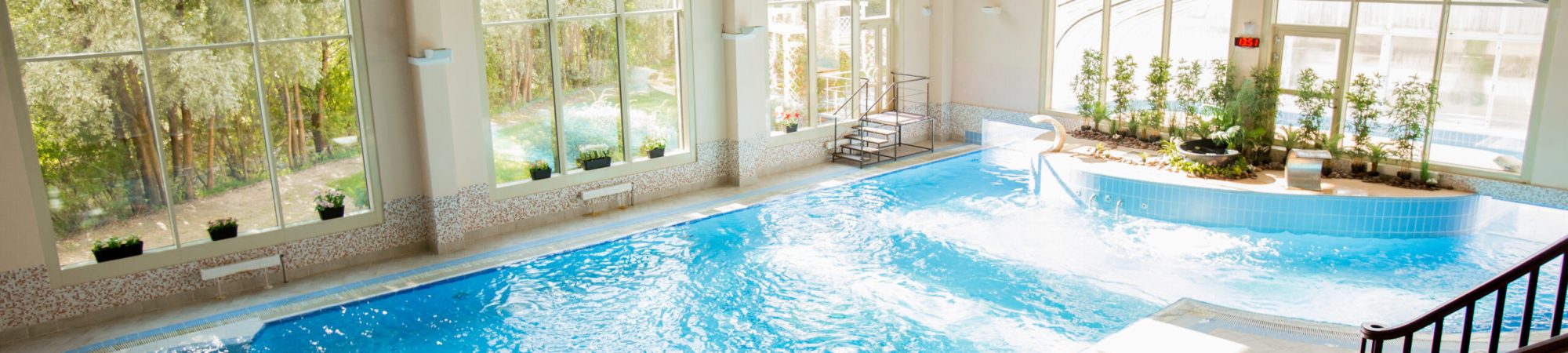 Spacious room with swimming-pool in its center at spa resort or hotel